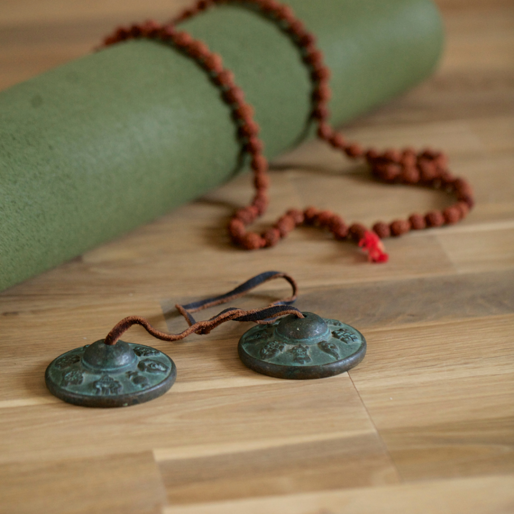 Teaching Yoga Without Cultural Appropriation: Yoga mat with Tingsha Chimes, and Rudraksha Beads